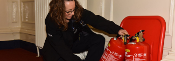 Fire protection staff checking fire extinguisher 